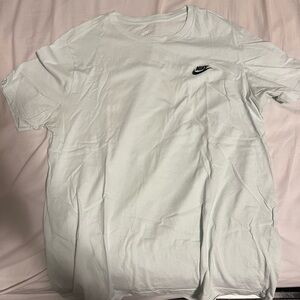 A teal Nike swish tee